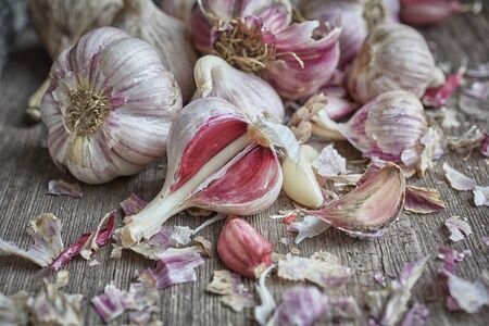Chilled garlic in a drawer. Fresh vegetables on the table. On a wooden backgroundの写真素材