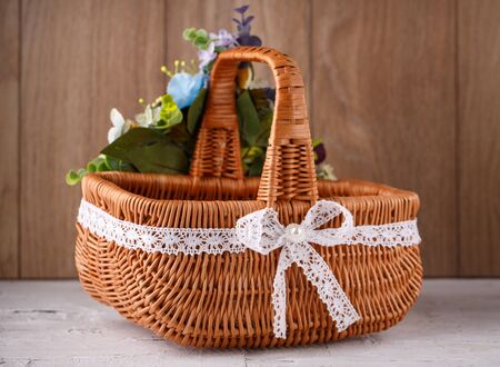 Originally decorated by flowers basket on a wooden backgroundの写真素材