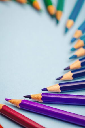Purple, blue and green pencils laid out in a semicircle with space for text. Educational background. selective focusの写真素材
