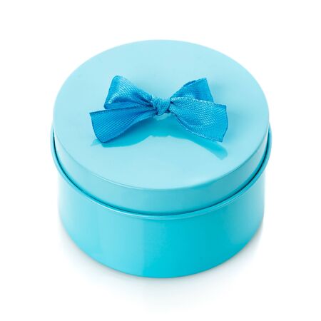 Single round turquoise gift box with blue bow on white backgroundの写真素材