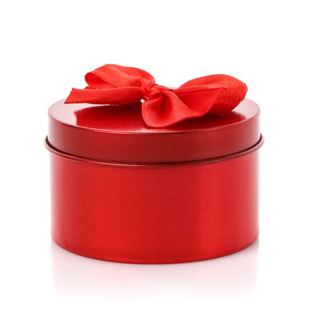 Single round red gift box with red bow on white backgroundの写真素材