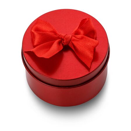 Single round red gift box with red bow on white background. Clipping path includedの写真素材