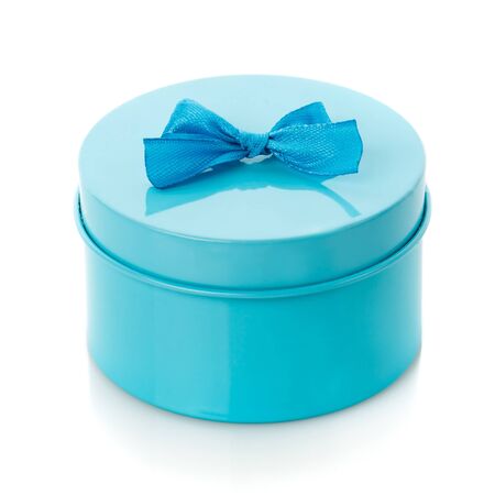 Turquoise gift box with blue bow on white background. Modern present for any holiday, christmas, valentine or birthdayの写真素材