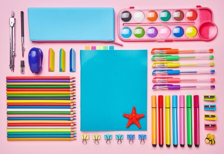 Desktop for the girl with her bright stationery. School and office supplies frame. Group of school supplies on table. Top view, Flat lay. copyspaceの写真素材