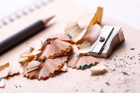 Sharpener, shavings and pencil on a white background. selective focus.の写真素材