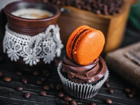 Chocolate cake with sweet hamburger. Cake on a wooden table next to the coffee.の写真素材
