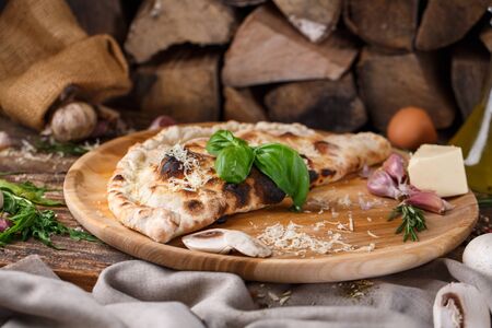 Pizza Calzone composed in half and baked. Mockup.の写真素材