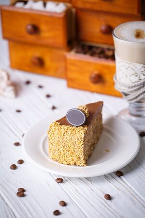 Walnut Cake with gold shavings on a white plateの写真素材