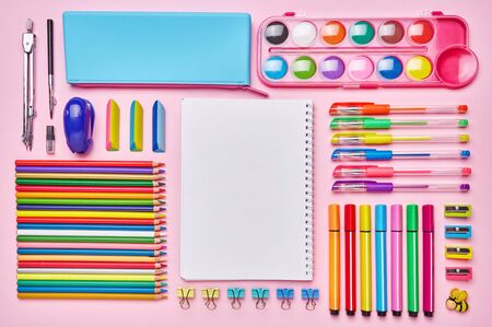 Bright composition from a school stationery on a pink background. School background. Concept of education or back to school. Flat lay. copyspaceの写真素材