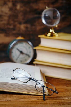 Education concept - books on the desk in the auditorium. Education and wisdom concept. selective focusの写真素材