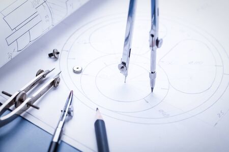 Compass drawing a circle on the drawing. Part of the industrial project. selective focusの写真素材
