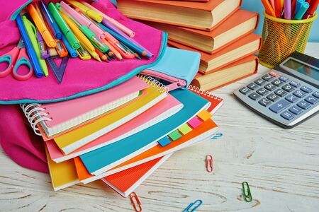 On the table is a composition of bright stationeryWorking place elements. Group of school supplies...