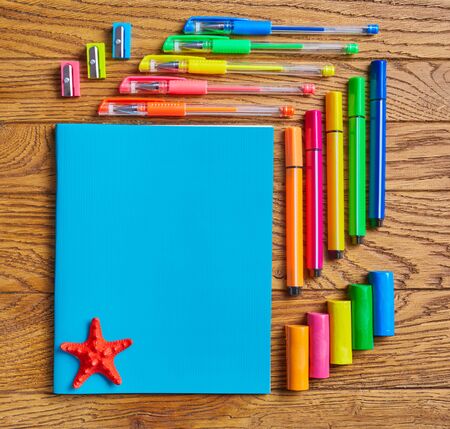 Educational background. Bright office supplies near a notebook with a star. Top view, flat layの写真素材