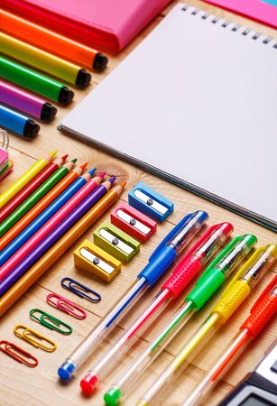 Bright stationery goods at the showcase in the store. School objects for students. On a wooden background. flat lay. copyspaceの写真素材