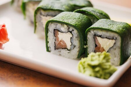 Traditional Japanese cuisine. Sushi with salmon and cheese are ready to be served. Delicious Japanese food. Close upの写真素材