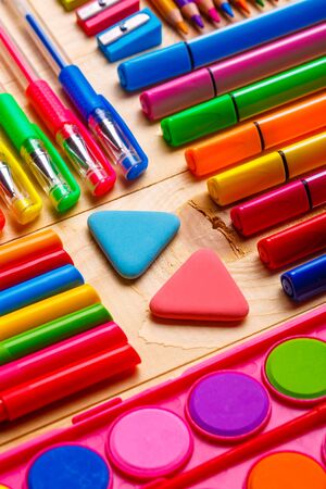 Stationery accessories are spread out on a wooden background. flat layの写真素材