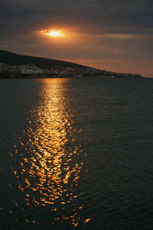 Sunset over the city on the seafront. Marine landscape. A nice place for rest and tourism. Sunny road on the sea reach. Bulgaria, Sveti Vlas, Nessebar, Sunny Beachの写真素材