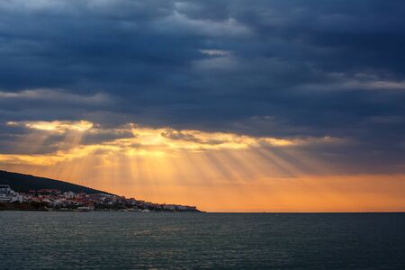 Sunset over the city on the seafront. Marine landscape. A nice place for rest and tourism. Bulgaria, Sveti Vlas, Black Sea,Sunny Beachの写真素材