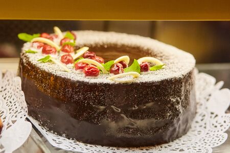 Tasty chocolate cake with cherries. Homemade baking. Holidays and dessert concept.