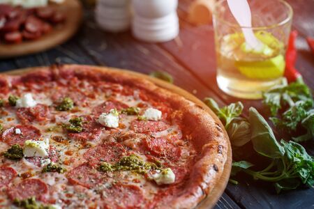 Traditional pizza. Lunch or dinner concept. Tasty fast food italian traditional on wooden table. Side viewの写真素材