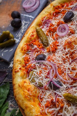 Traditional pizza. Lunch or dinner concept. Tasty fast food italian traditional on wooden table. Side viewの写真素材