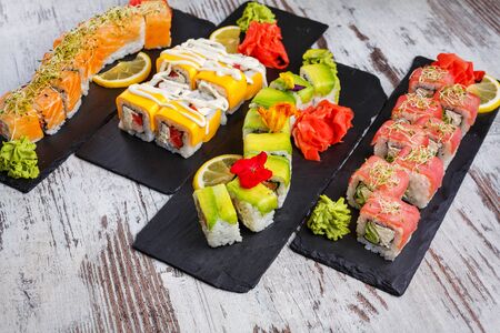 Sushi sets of different types of sushi are cured for serving in a restaurant. Delicious Japanese cuisine.の写真素材