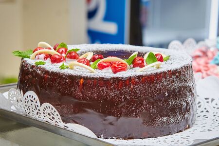 Tasty chocolate cake with cherries. Homemade baking. Holidays and dessert concept.
