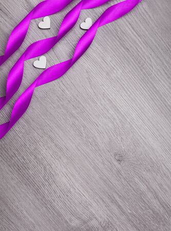 Violet ribbon in the form of a spiral and decorative heart.. Mother's day. Women's day. Valentine's day, Birthday greeting concept background. top view, flat lay, mockupの写真素材