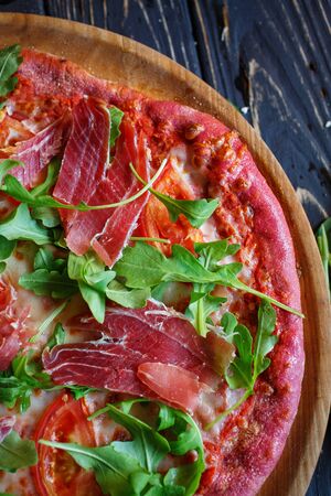 Tasty appetizing classic italian traditional pizza. Concept for a tasty and hearty meal. Rustic wooden background. Pizza menu.の写真素材