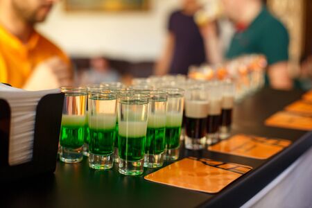 Alcoholic drink, creative stimulant and bohemian lifestyle concept. Green alcoholic cocktail at the bar. Shot.の写真素材