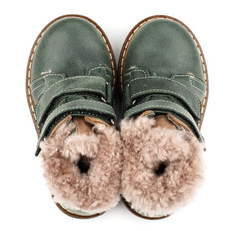 Green baby shoes with fur for boys on a white background. Photo for shoes advertisement. Top viewの写真素材