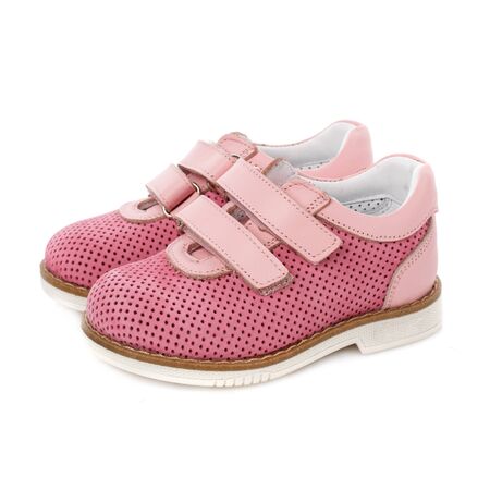 Children's pink shoes for girls on a white background. Photo for shoes advertisement. Side viewの写真素材