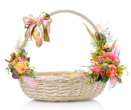 Beautiful Easter basket and with delicate decor on a white backgroundの写真素材