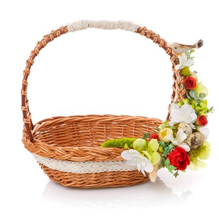 Brown wicker basket with floral decor and ribbons. Isolatedの写真素材
