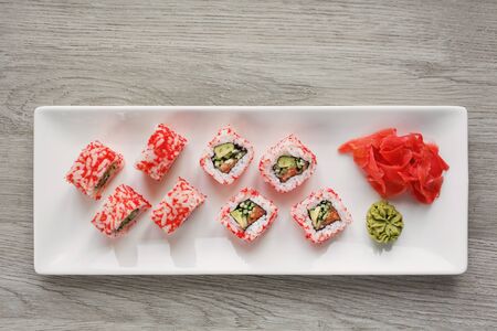 Sushi with ginger and wasabi. Japanese food. Sushi roll set with vegetables, fish and caviar closeup. Japanese restaurant menu. Top view. Place for textの写真素材