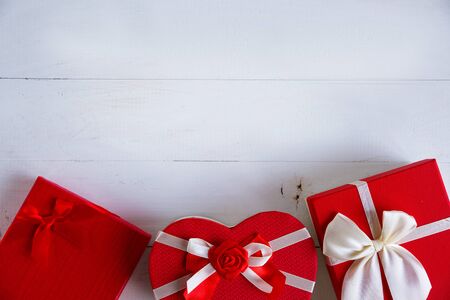 Red gift boxes on wooden white background. Concept of love stories and for Valentine's Day. Top view. Place for textの写真素材
