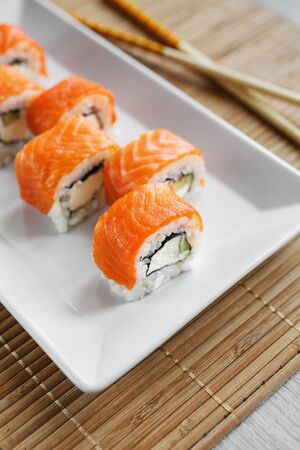 Sushi roll with salmon, avocado and cheese. Sushi menu. Japanese food.の写真素材