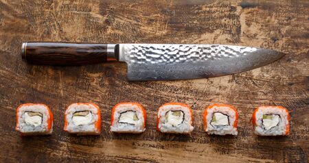 Beautiful Philadelphia sushi rolls with salmon and cream cheese and cucumber on wooden background.の写真素材