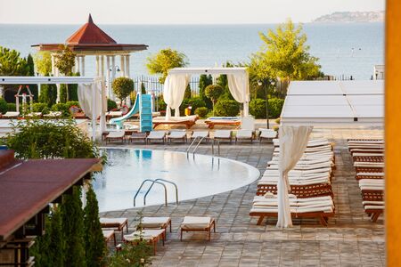 Relaxation area by the pool. Summer holiday in the hotel. Empty space for rest. Luxury place resort and spa for vacationsの写真素材
