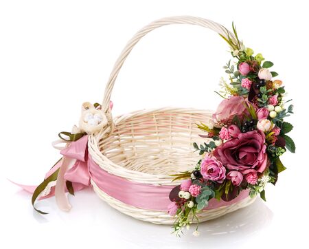 Original wicker basket with a beautiful, delicate pink decor with a pink ribbon around the basket and a small decorative nest with quail eggs. On a white background.の写真素材