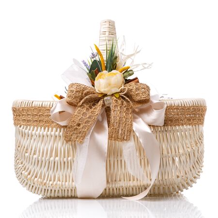 Beautiful decorative basket with flowers for Easter celebration, isolated on a white backgroundの写真素材