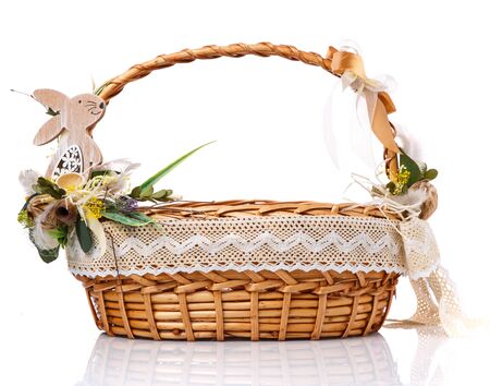 Wicker basket with original floral decor with natural components and a wooden hare. Isolated on white background.の写真素材