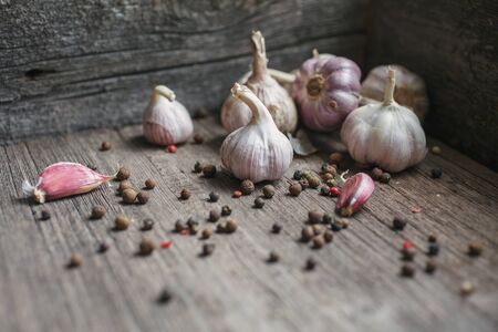 Garlic and peas peppers on wooden background. Ingredients for cooking. Cooking background.