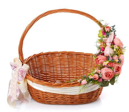 Beautiful decorative basket with flowers for Easter celebration, isolated on a white backgroundの写真素材
