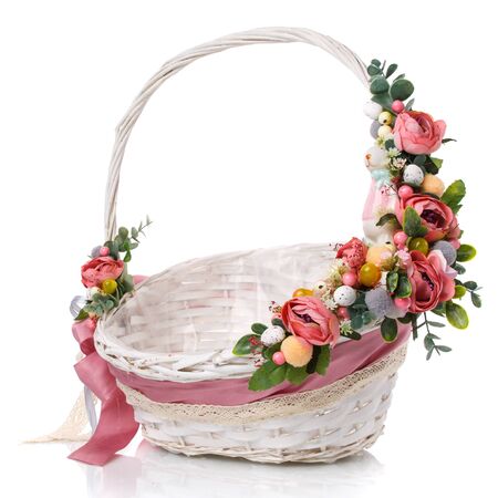 Provence Easter floral arrangement on a white wicker basket with a vine. Isolatedの写真素材