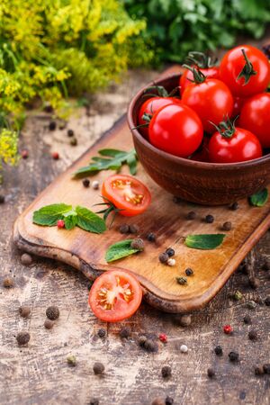 Cooking background. Fresh vegetables and peppers on wooden background. Ripe tomatoes and herbs. Food photo.の写真素材