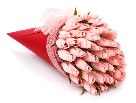 Pink tulips with candy inside made of corrugated paper in a red wrap with lace on a white background. Delicious holiday gift. Handmade.の写真素材