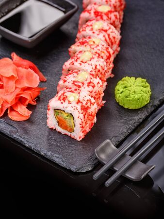 Sushi with chopsticks, ginger, soy sauce and wasabi. Japanese food. Set of sushi roll with vegetables, fish and caviar. Japanese menu.の写真素材