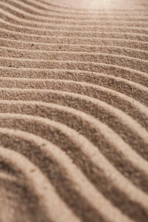 Sand on the beach close up. Wavy texture sand. Selective focus.の写真素材