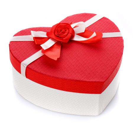 Red and white gift box in the form of a heart with a flower in the middle. Isolated on white background. Surprise for the holidays.の写真素材